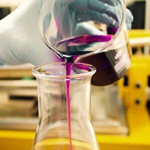 A person pouring liquid into a glass.