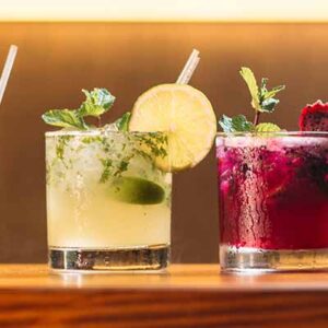 Three different drinks are sitting on a table.